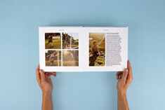 High-quality photo book, lay-flat hardcover, square format, detailed open book view